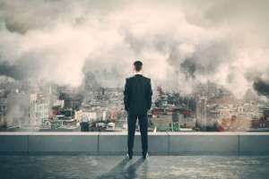 Stay on Top of Your Business's Online Presence with Words4Profit's Expert Digital Marketing Services - Image of a Man Watching the Burning City Below Man standing on top of a building, watching the burning and smoking city below, representing the importance of staying on top of your business's online presence with Words4Profit's expert digital marketing services.